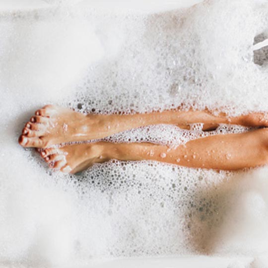 Feet in soapy water