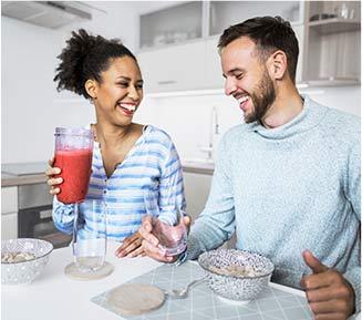 Man and woman smiling in kitchen